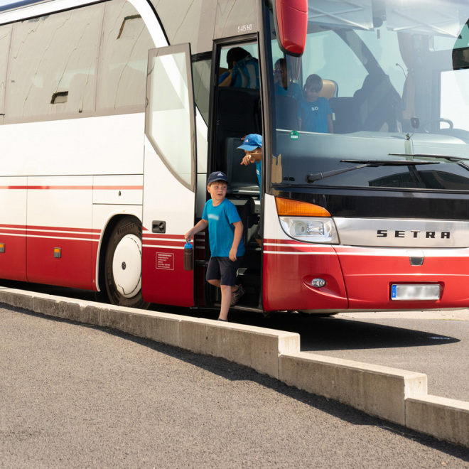 Coronahilfe Schülerverkehr (im Bild: Kinder steigen aus einem Bus aus)