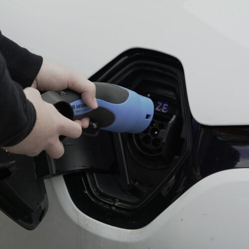 Ein E-Auto wird an eine Ladesäule angeschlossen.