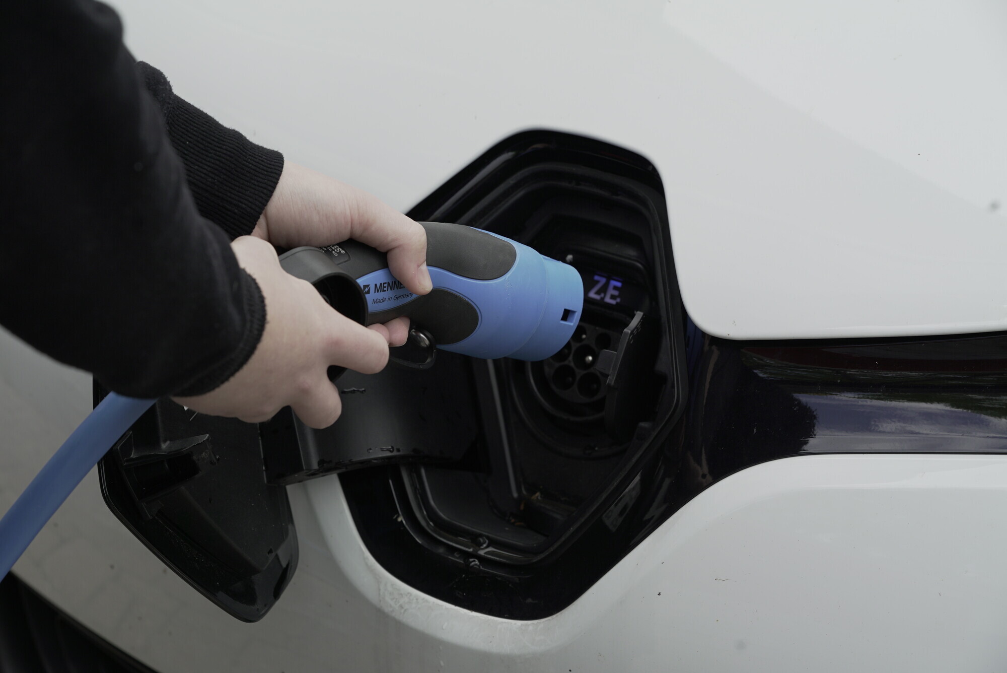 Ein E-Auto wird an eine Ladesäule angeschlossen.